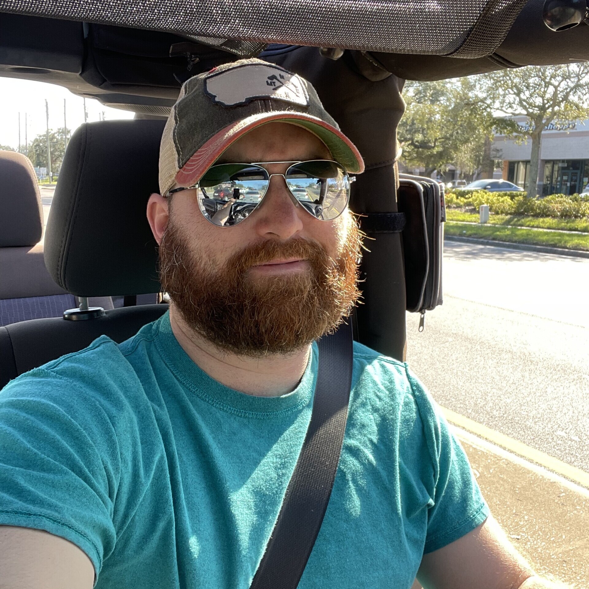 a selfie of myself driving a jeep with the top down